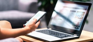 Wireless wifi for remote work in airport lounge bar, hotel lobby or cafe. Phone and laptop. Woman using smartphone and modern notebook pc computer on table. Real estate agent or student reading email.